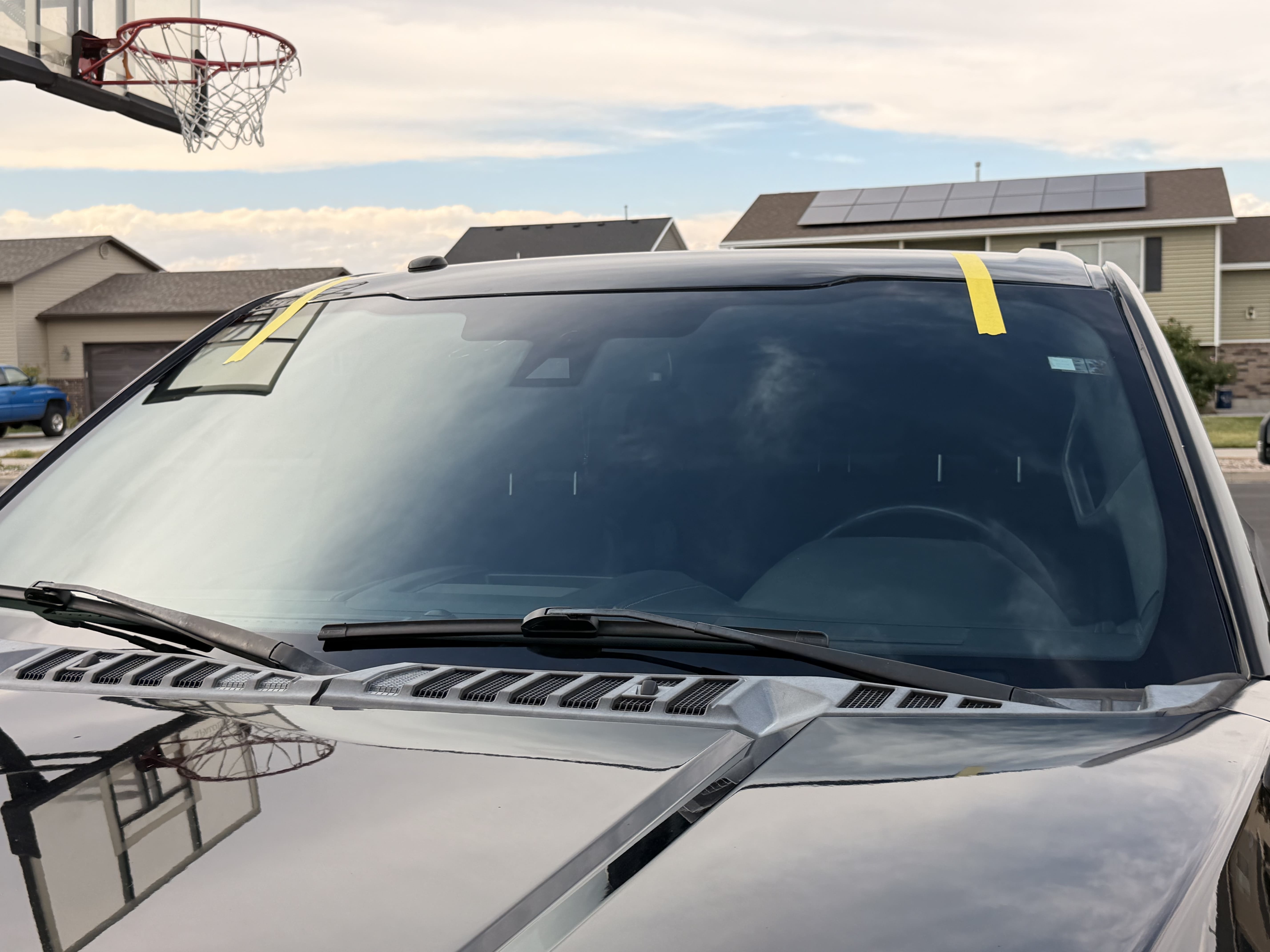 Close-up of a freshly installed windshield on a black truck